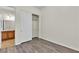 Cozy bedroom with wood-look floors leading to closet and bathroom at 2673 Paris Amour St, Henderson, NV 89044