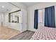 Bedroom with blue curtains and bed, showcasing an archway to other areas of the house at 2673 Paris Amour St, Henderson, NV 89044
