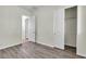 Bedroom with wood-look floors, closet and multiple doors at 2673 Paris Amour St, Henderson, NV 89044