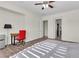 Bedroom featuring a ceiling fan, wood-look floors, and an adjacent study area at 2673 Paris Amour St, Henderson, NV 89044