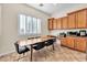 The dining area includes wood cabinets, a built-in desk, and a window providing natural light at 2673 Paris Amour St, Henderson, NV 89044