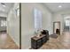 Well-lit hallway boasting tile flooring, with a view of bedroom and access to bathroom at 2673 Paris Amour St, Henderson, NV 89044