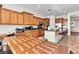 Spacious kitchen featuring wooden cabinets, granite countertops, and a central island with bar seating at 2673 Paris Amour St, Henderson, NV 89044