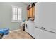Laundry room with washer, dryer and a storage cabinet with shuttered window at 2673 Paris Amour St, Henderson, NV 89044