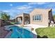 Outdoor oasis featuring a private pool, covered patio, and lush artificial turf for easy maintenance at 2673 Paris Amour St, Henderson, NV 89044