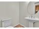 Powder room with neutral paint, decorative mirror, and pedestal sink at 2673 Paris Amour St, Henderson, NV 89044