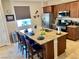 Bright kitchen features a granite island with seating, stainless appliances, and wood cabinets at 2719 Chinaberry Hill St, Laughlin, NV 89029