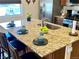 Granite island with sink, faucet, breakfast bar and seating at 2719 Chinaberry Hill St, Laughlin, NV 89029