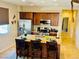 Bright kitchen features a granite island with seating, stainless appliances, and wood cabinets at 2719 Chinaberry Hill St, Laughlin, NV 89029