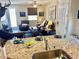 Modern living space integrates living room and kitchen, complete with granite counters and stylish decor at 2719 Chinaberry Hill St, Laughlin, NV 89029