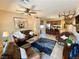 Open-concept living and kitchen area with sleek appliances and granite countertop island with bar stool seating at 2719 Chinaberry Hill St, Laughlin, NV 89029