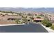 Street view of a neighborhood, showcasing the well-maintained roads and beautiful landscaping at 2719 Chinaberry Hill St, Laughlin, NV 89029