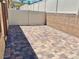 Paver patio surrounded by a tall privacy fence and retaining wall, creating an inviting outdoor space at 2719 Chinaberry Hill St, Laughlin, NV 89029