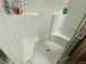 Modern shower with white tiled walls, and built-in seat at 2719 Chinaberry Hill St, Laughlin, NV 89029