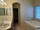Primary bathroom with double sinks, soaking tub, and a separate walk-in closet at 2855 Grande Valley Dr, Las Vegas, NV 89135