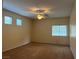 Spacious carpeted bedroom with natural light, ceiling fan, and multiple windows at 2855 Grande Valley Dr, Las Vegas, NV 89135