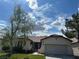 Charming single-story home featuring a tile roof and well-maintained front yard with mature tree at 2855 Grande Valley Dr, Las Vegas, NV 89135