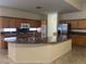 Open kitchen featuring granite countertops, wood cabinetry, and stainless steel appliances, adjoining an island at 2855 Grande Valley Dr, Las Vegas, NV 89135