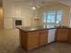 Well-lit kitchen featuring a granite island with breakfast bar and stainless steel appliances, connecting to living area at 2855 Grande Valley Dr, Las Vegas, NV 89135