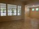 Bright living room area with large windows and neutral tile floors, showcasing the home's interior at 2855 Grande Valley Dr, Las Vegas, NV 89135