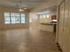 Spacious living room with tile floors and large windows overlooking the yard, open to a kitchen area at 2855 Grande Valley Dr, Las Vegas, NV 89135