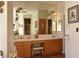 A spacious bathroom with a double sink vanity, large mirror, and warm wood cabinets at 325 Wild Plum Ln, Las Vegas, NV 89107
