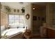 Bright bathroom with lots of natural light, a soaking tub, and decorative elements at 325 Wild Plum Ln, Las Vegas, NV 89107