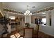 Open floor plan dining room features a chandelier, and kitchen access at 325 Wild Plum Ln, Las Vegas, NV 89107