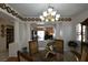 The dining room is open to the living room and features a stylish chandelier at 325 Wild Plum Ln, Las Vegas, NV 89107