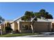 Charming single-story home with a well-manicured lawn, desert landscaping, and a two car garage at 325 Wild Plum Ln, Las Vegas, NV 89107