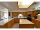 Bright eat-in kitchen with tile backsplash and an island with counterspace at 325 Wild Plum Ln, Las Vegas, NV 89107