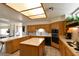 Well lit kitchen features tile counters, center island, and wood cabinets at 325 Wild Plum Ln, Las Vegas, NV 89107