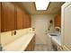 Efficient laundry room with ample cabinet space, a bright skylight, and modern washer and dryer units at 325 Wild Plum Ln, Las Vegas, NV 89107