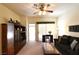 Spacious living room with a ceiling fan, comfortable seating, and sliding glass doors at 325 Wild Plum Ln, Las Vegas, NV 89107