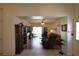 Spacious living room with wood floors, a ceiling fan, and sliding glass doors to the backyard at 325 Wild Plum Ln, Las Vegas, NV 89107