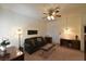 Cozy living room featuring a ceiling fan, sofa, and desk with lots of natural light at 325 Wild Plum Ln, Las Vegas, NV 89107