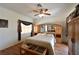 Bright main bedroom featuring hardwood floors and a ceiling fan at 325 Wild Plum Ln, Las Vegas, NV 89107