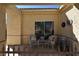 Inviting covered patio with chairs, perfect for relaxing and enjoying the desert scenery at 325 Wild Plum Ln, Las Vegas, NV 89107
