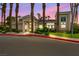 View of the Quail Ridge clubhouse framed by towering palm trees and lush landscaping at 3342 Pheasant Canyon Way # 1013, Laughlin, NV 89029