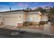 Single-story home boasting a low-maintenance yard, private two-car garage, and warm exterior lighting at 3342 Pheasant Canyon Way # 1013, Laughlin, NV 89029