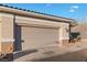 Close-up of a two-car garage with desert-style landscaping at 3342 Pheasant Canyon Way # 1013, Laughlin, NV 89029
