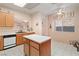 Bright kitchen features an island, plenty of counter space, stainless steel dishwasher, and tiled floor at 3342 Pheasant Canyon Way # 1013, Laughlin, NV 89029
