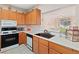 Cozy kitchen showcasing white countertops, a dark sink, tiled floors, and stainless steel appliances at 3342 Pheasant Canyon Way # 1013, Laughlin, NV 89029