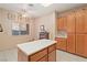 Well-lit kitchen with white countertops, wood cabinets, tile floors, and stainless steel appliances at 3342 Pheasant Canyon Way # 1013, Laughlin, NV 89029