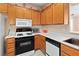 Charming kitchen featuring tiled floors, stainless steel appliances, and warm wood cabinetry at 3342 Pheasant Canyon Way # 1013, Laughlin, NV 89029