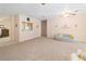 Open-concept living room with ample space features neutral paint, carpet, and a view of the kitchen at 3342 Pheasant Canyon Way # 1013, Laughlin, NV 89029