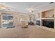 Bright living room with a fireplace, a large window, and a sliding glass door to the outside at 3342 Pheasant Canyon Way # 1013, Laughlin, NV 89029