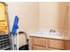 A handy utility sink with storage underneath is situated next to a yellow and grey step ladder at 3342 Pheasant Canyon Way # 1013, Laughlin, NV 89029