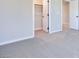Neutral bedroom with plush carpet and access to an open closet space, offering a comfortable and functional living area at 3357 Via Tizzoni St, Henderson, NV 89044