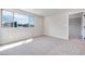 Well-lit bedroom with plush carpeting, large window, and an open doorway at 3357 Via Tizzoni St, Henderson, NV 89044